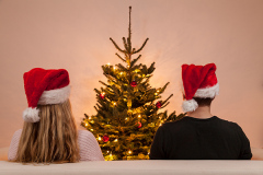 couple with caps on christmas eve
