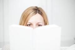 woman attentively reads a book